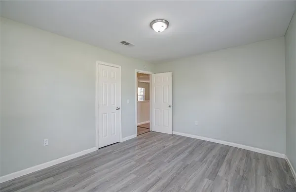 a view of an empty room and wooden floor