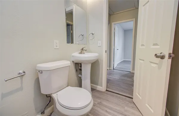 a white toilet sitting next to a bathroom sink