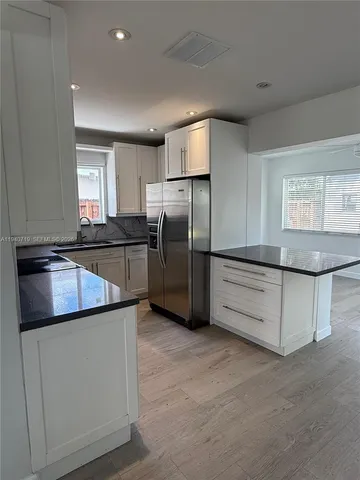 a kitchen with stainless steel appliances a refrigerator and a sink