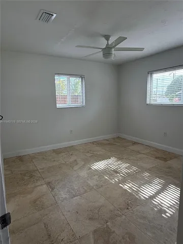 a view of an empty room and wooden floor