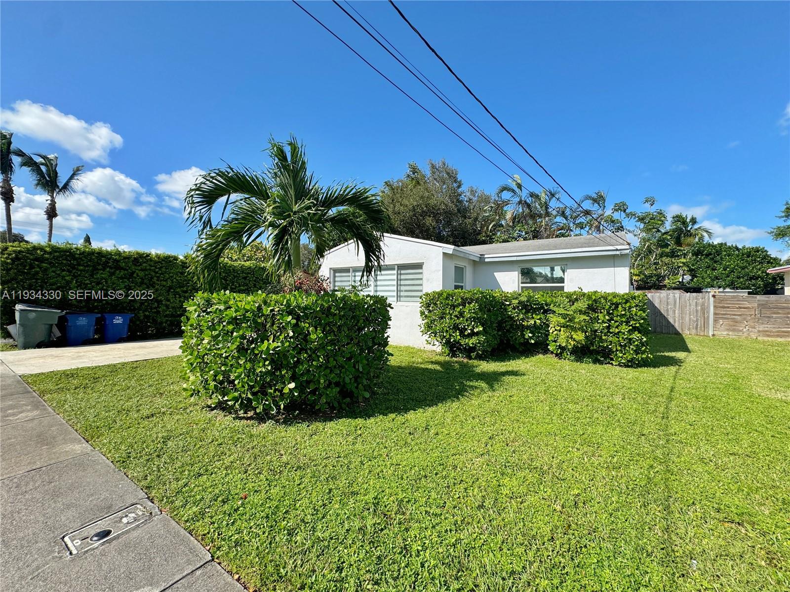 640 Southwest 6th Street Hallandale Beach, FL 33009 - Photo 15 of 18 a view of a house with a yard