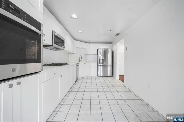 a large white kitchen with white cabinets