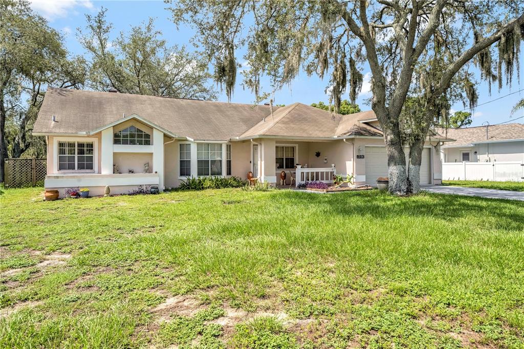 12196 Bluefield Street Spring Hill, FL 34609 - Photo 14 of 47 a front view of house with yard and green space