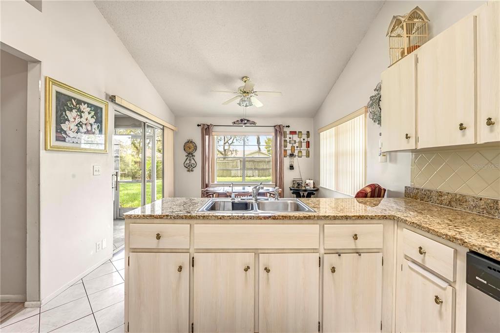 12196 Bluefield Street Spring Hill, FL 34609 - Photo 15 of 47 a kitchen with stainless steel appliances cabinets and a large window