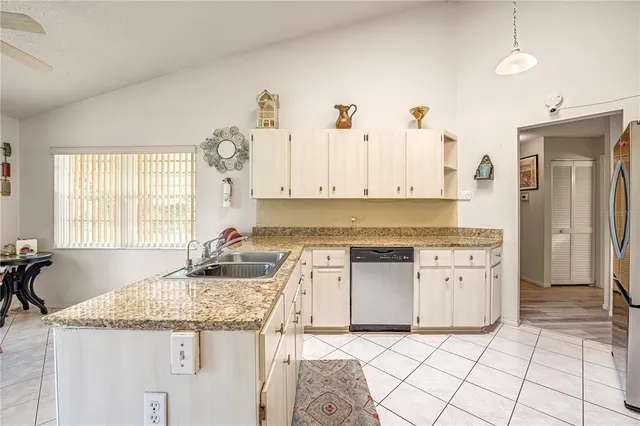 a kitchen with granite countertop a sink and a stove