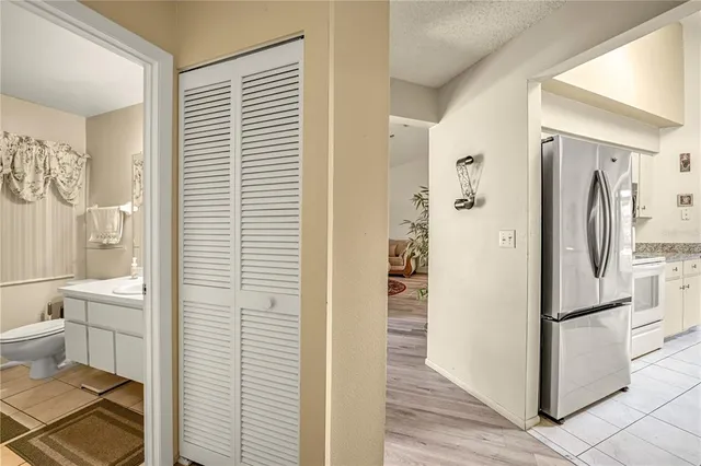 a bathroom with a refrigerator and a window