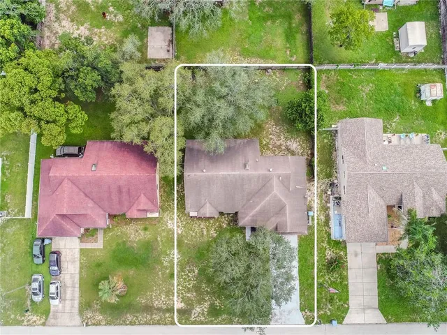 an aerial view of a house with outdoor space and street view
