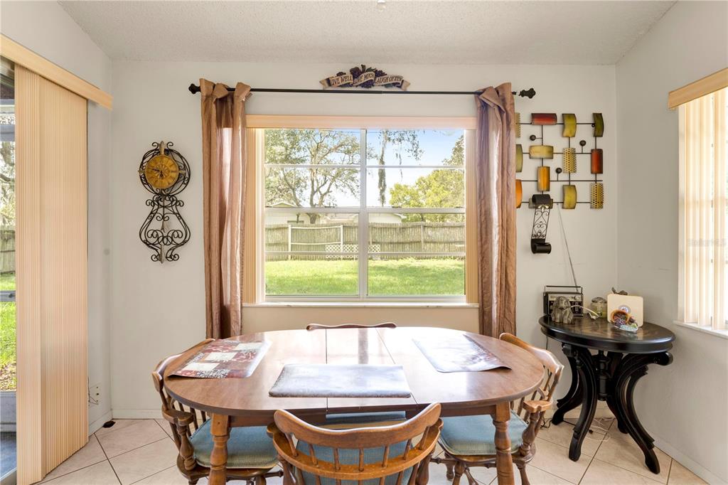 12196 Bluefield Street Spring Hill, FL 34609 - Photo 22 of 47 a dining room with a table and chairs