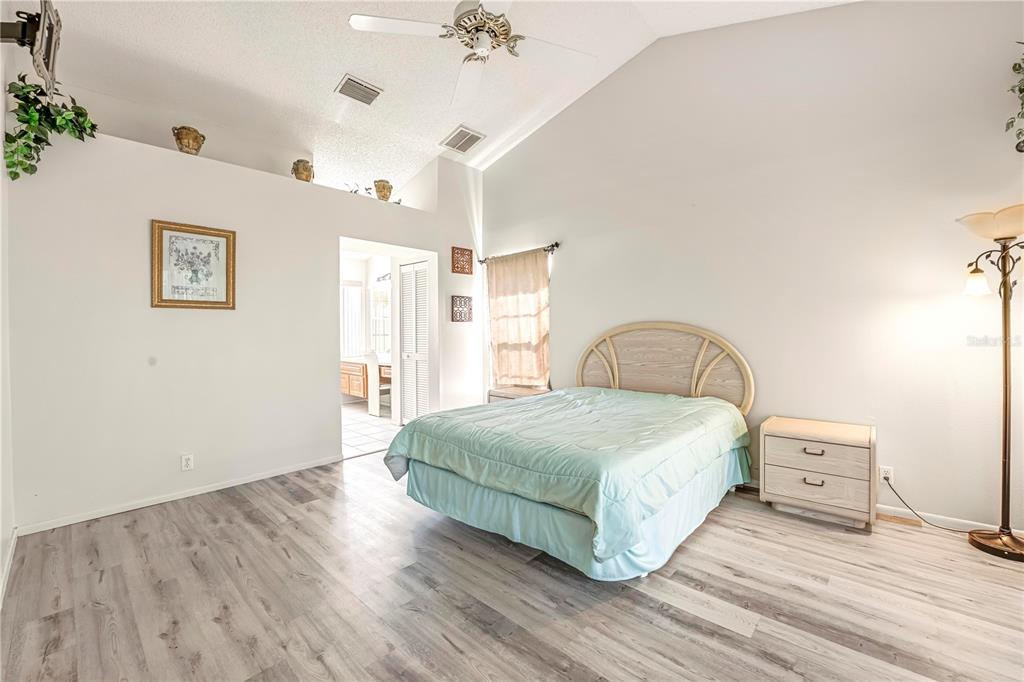 12196 Bluefield Street Spring Hill, FL 34609 - Photo 25 of 47 a bedroom with a bed and a dresser