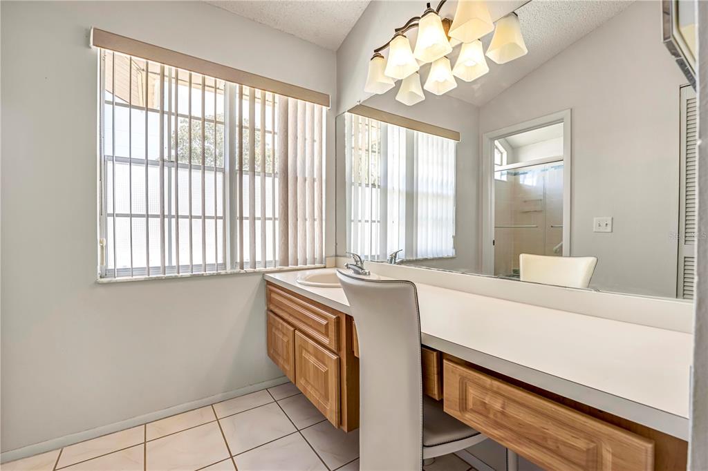 12196 Bluefield Street Spring Hill, FL 34609 - Photo 30 of 47 a room with a bed and a chandelier