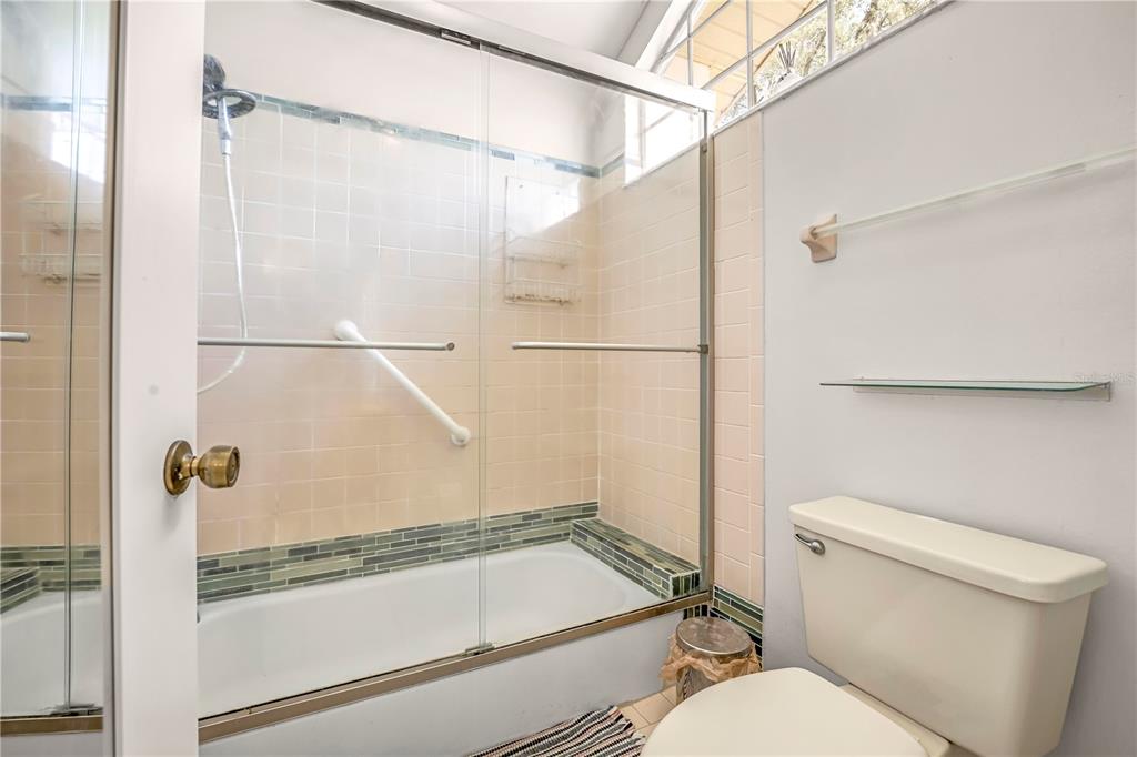 12196 Bluefield Street Spring Hill, FL 34609 - Photo 31 of 47 a bathroom with a shower and toilet