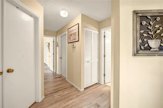 a view of a hallway with wooden floor