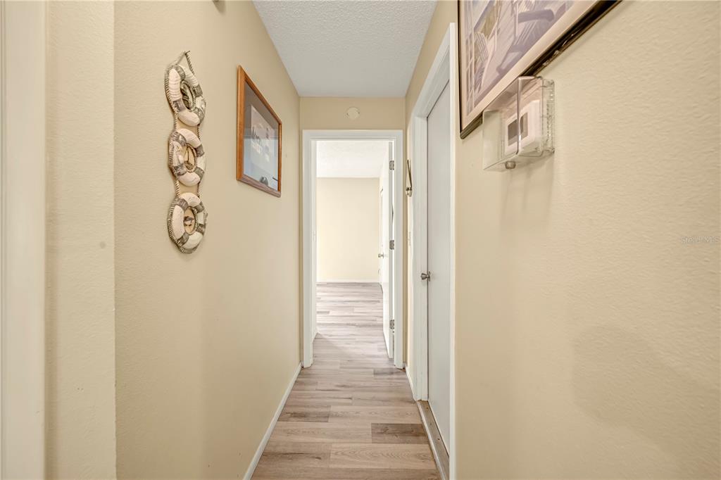 12196 Bluefield Street Spring Hill, FL 34609 - Photo 34 of 47 a view of a hallway with wooden floor and closet