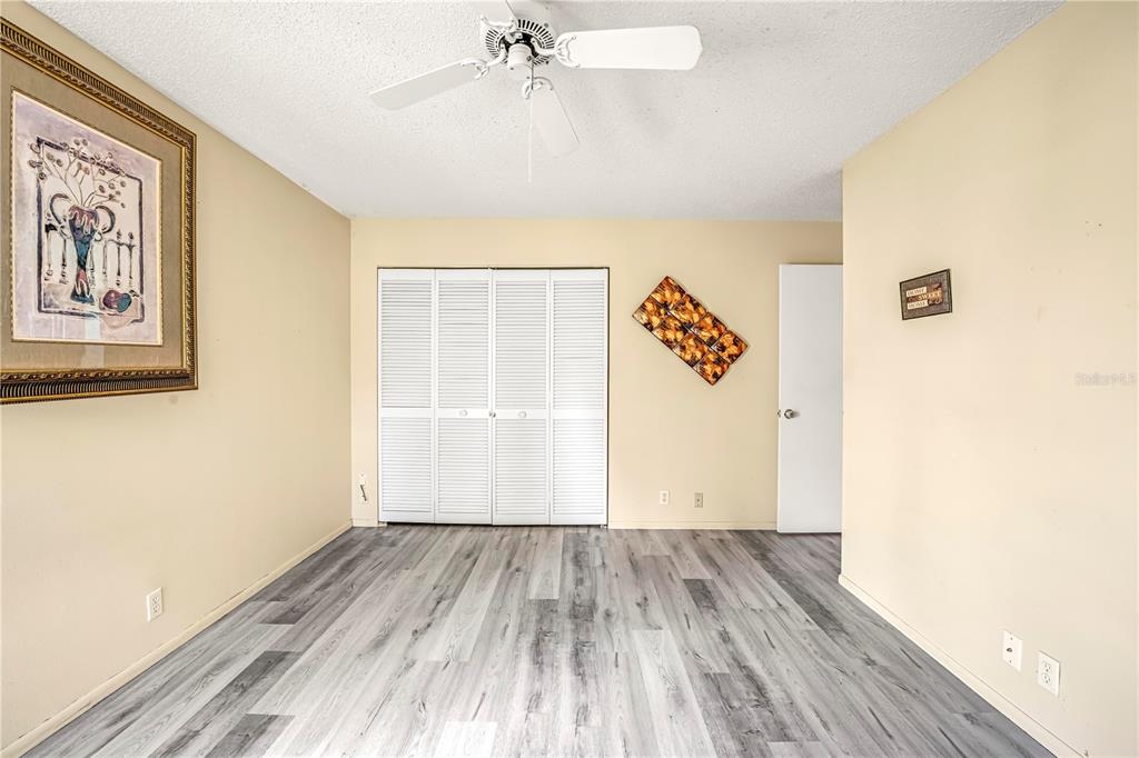 12196 Bluefield Street Spring Hill, FL 34609 - Photo 37 of 47 an empty room with wooden floor and windows