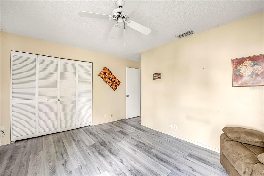 12196 Bluefield Street Spring Hill, FL 34609 - Photo 38 of 47 a view of an empty room with wooden floor