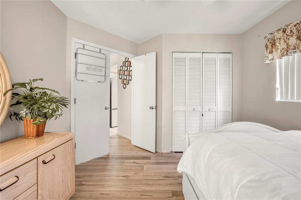 12196 Bluefield Street Spring Hill, FL 34609 - Photo 42 of 47 a bedroom with a bed potted plant with the wooden floor