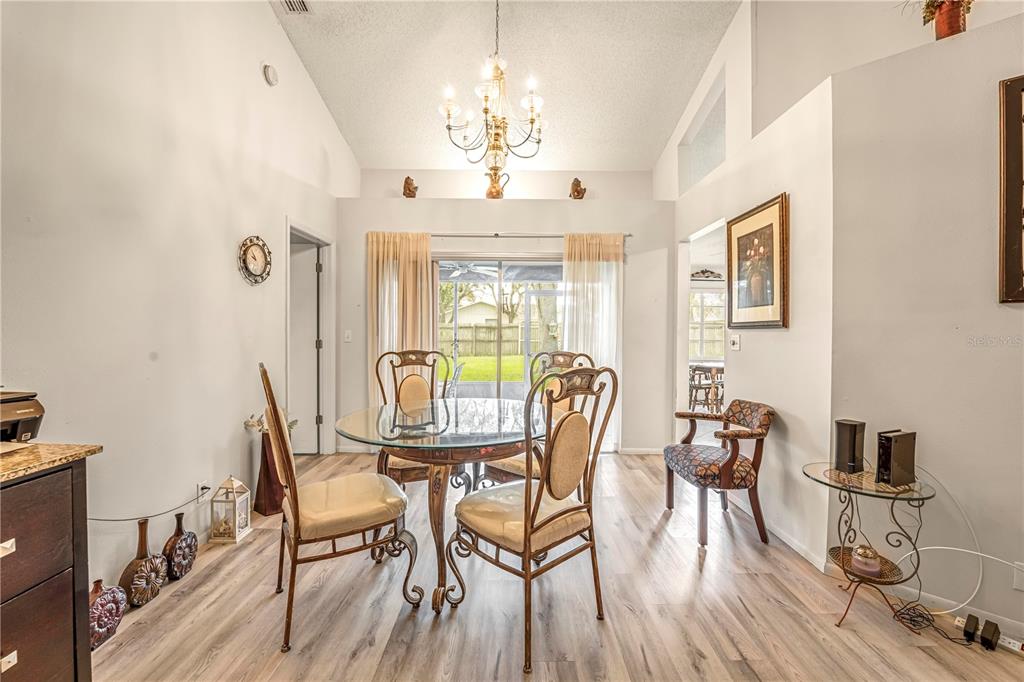 12196 Bluefield Street Spring Hill, FL 34609 - Photo 6 of 47 a view of a dining room with furniture window and wooden floor