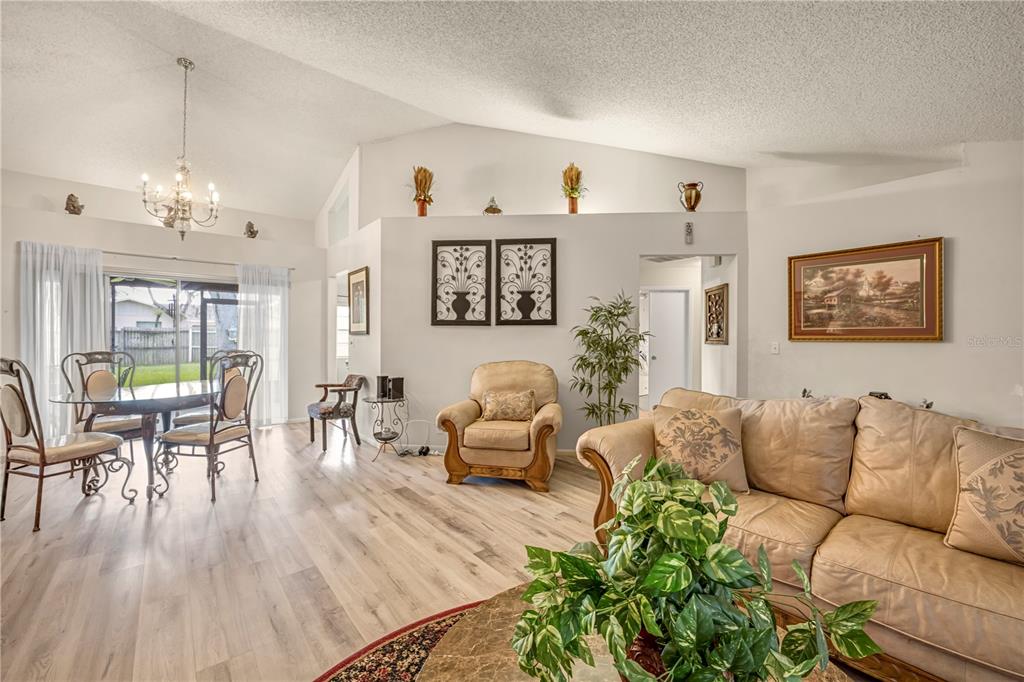 12196 Bluefield Street Spring Hill, FL 34609 - Photo 8 of 47 a living room with furniture and wooden floor