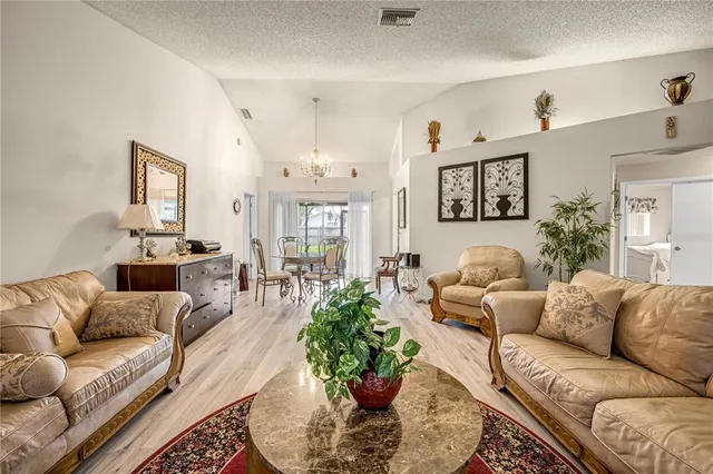 a living room with furniture potted plant and a window
