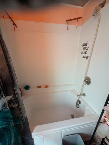 a bathroom with a tub and shower