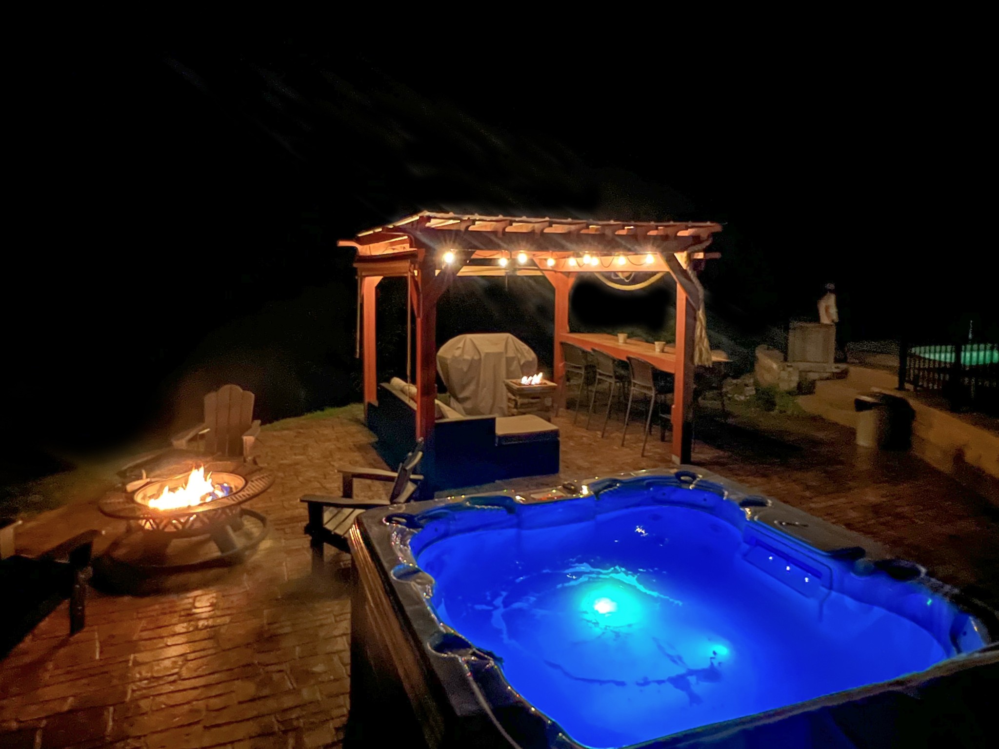 a view of a pool with a dining table and chairs with wooden floor
