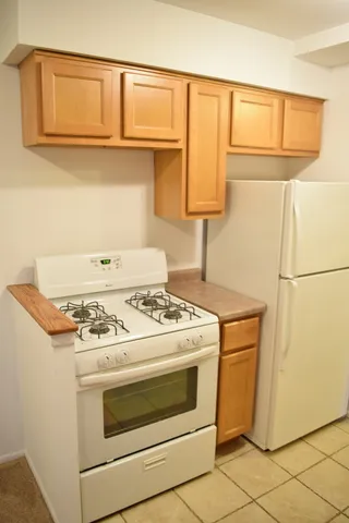 a stove top oven sitting inside of a kitchen