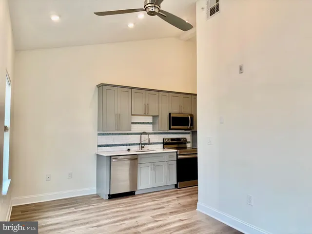 a kitchen with stainless steel appliances a stove and a refrigerator
