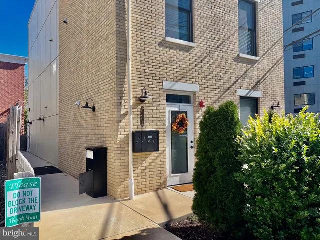 front view of a brick house with a small yard