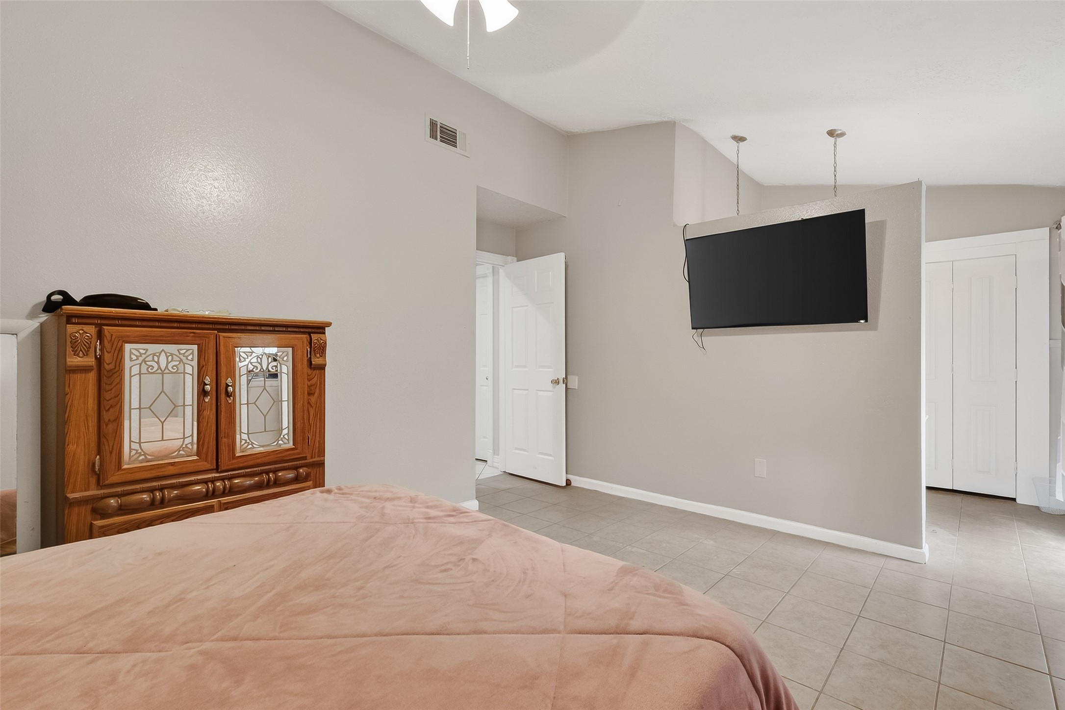 9718 Whitepost Lane Houston, TX 77086 - Photo 14 of 18 a bedroom with a bed and a flat screen tv