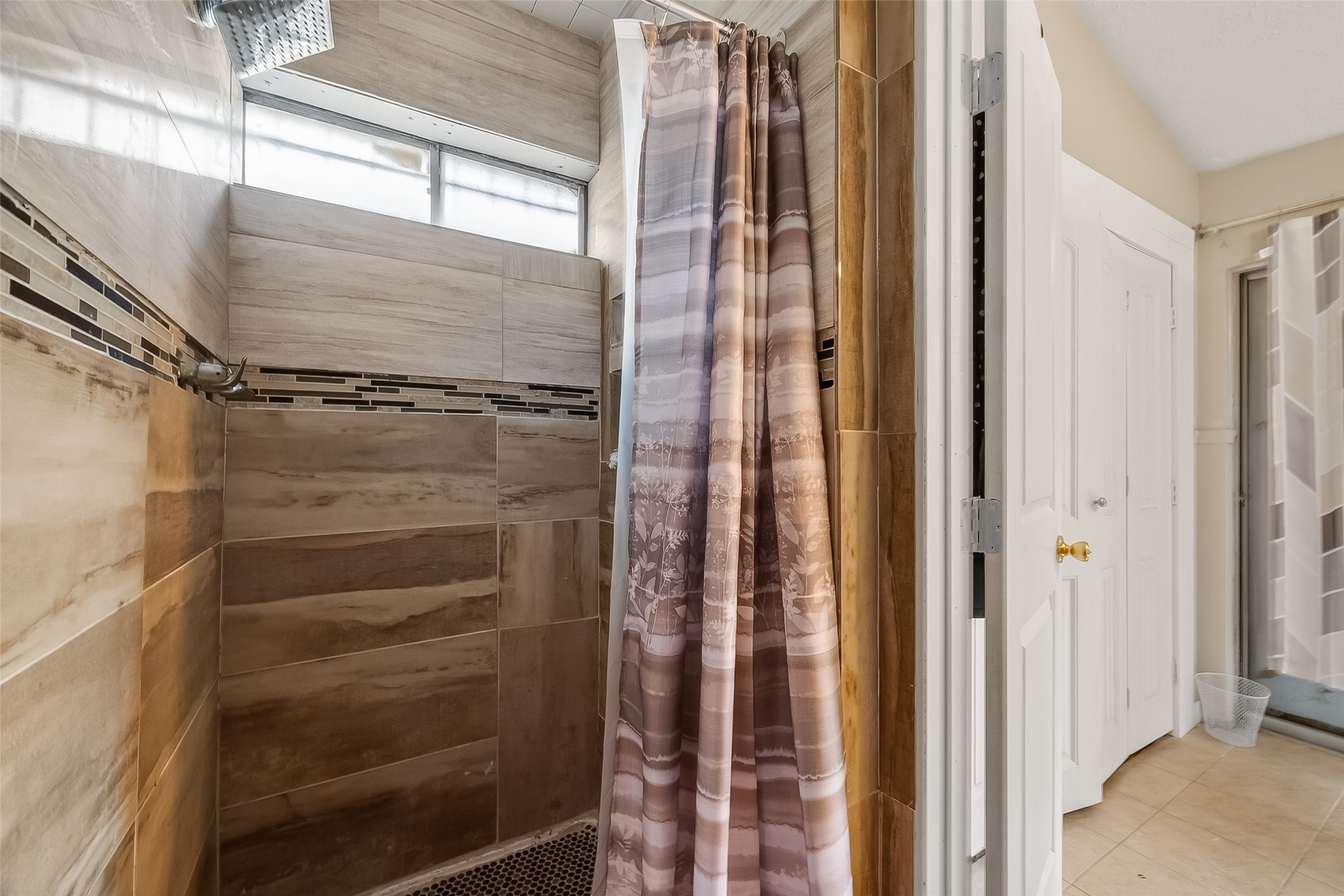 9718 Whitepost Lane Houston, TX 77086 - Photo 17 of 18 a bathroom with a glass shower door