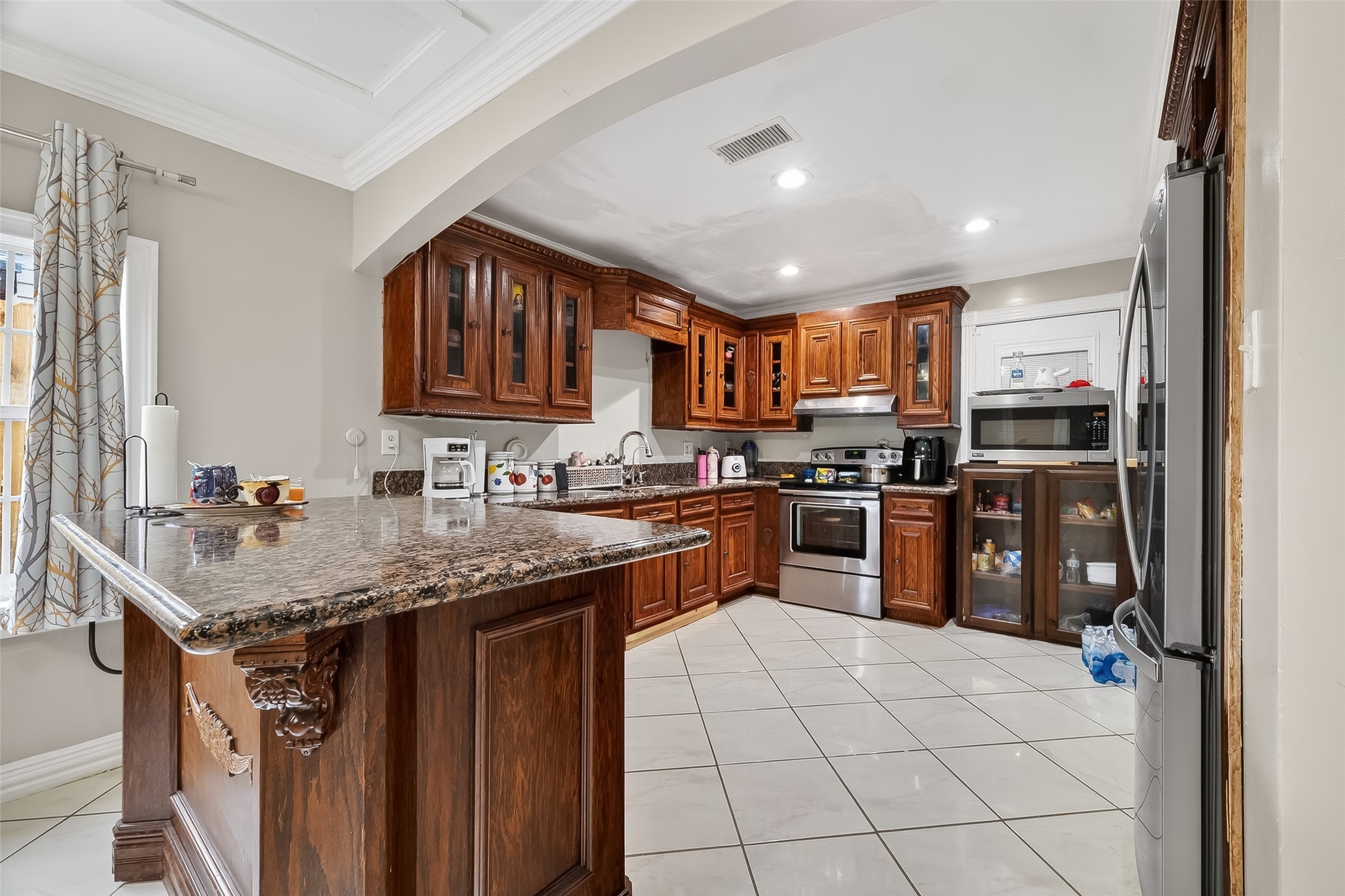 9718 Whitepost Lane Houston, TX 77086 - Photo 7 of 18 a kitchen with stainless steel appliances granite countertop a sink stove and refrigerator
