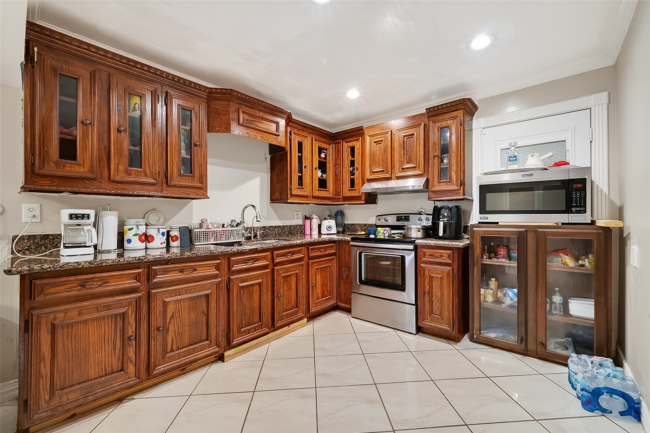 9718 Whitepost Lane Houston, TX 77086 - Photo 8 of 18 a kitchen with stainless steel appliances granite countertop a stove top oven a sink dishwasher and cabinets with wooden floor