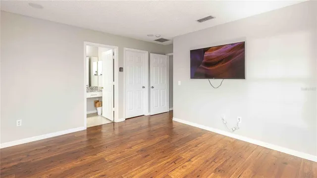 a view of a room with wooden floor and brick wall