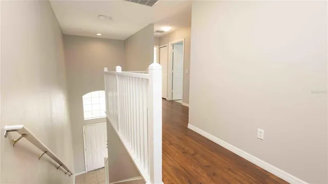 a view of a room with wooden floor and white walls