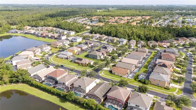 an aerial view of residential houses with outdoor space and river