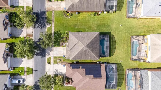 an aerial view of multiple houses with a yard