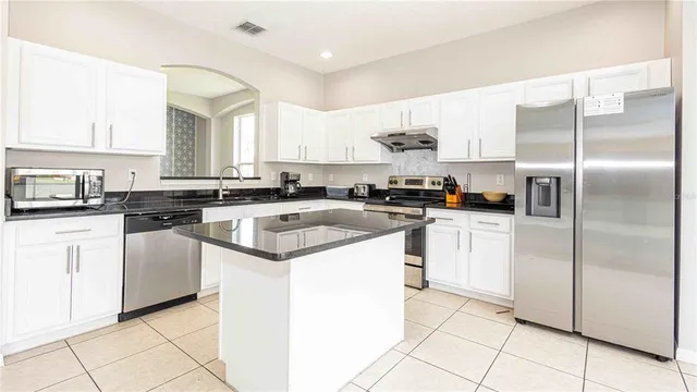 a kitchen with cabinets and stainless steel appliances