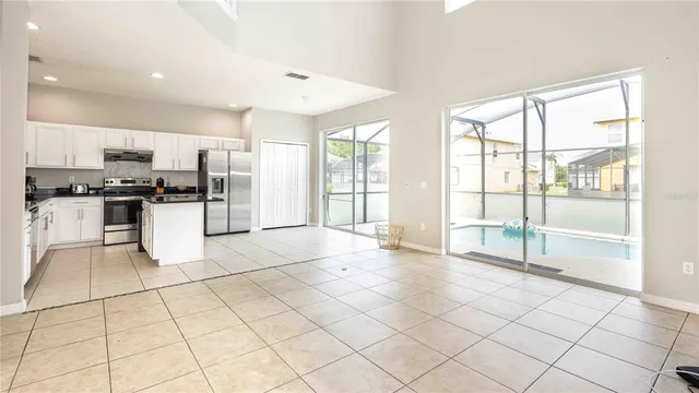 a large white kitchen with cabinets and a stove top oven
