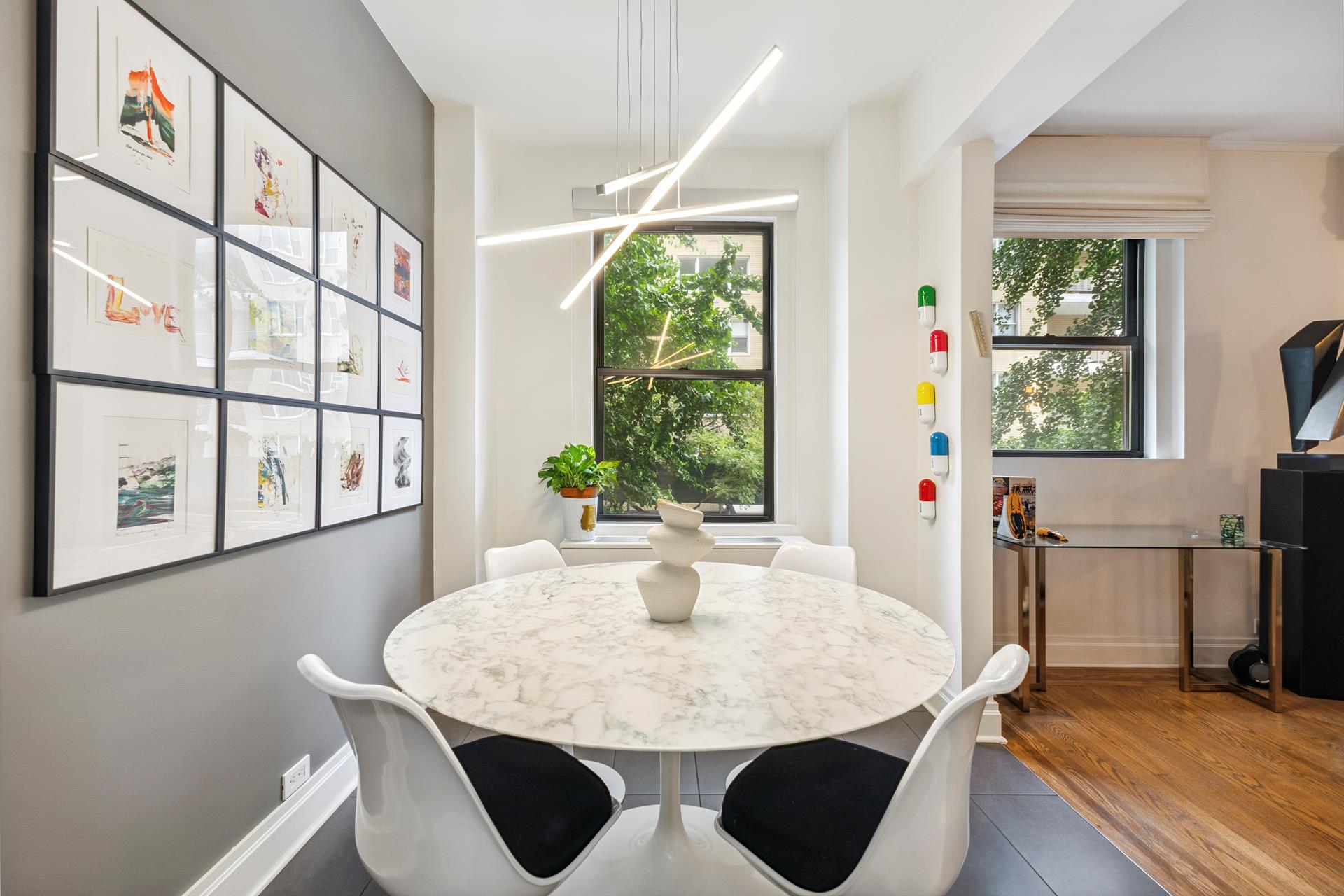 242 East 19th Street, Unit 2C Manhattan, NY 10003 - Photo 5 of 9 a dining room with furniture and window
