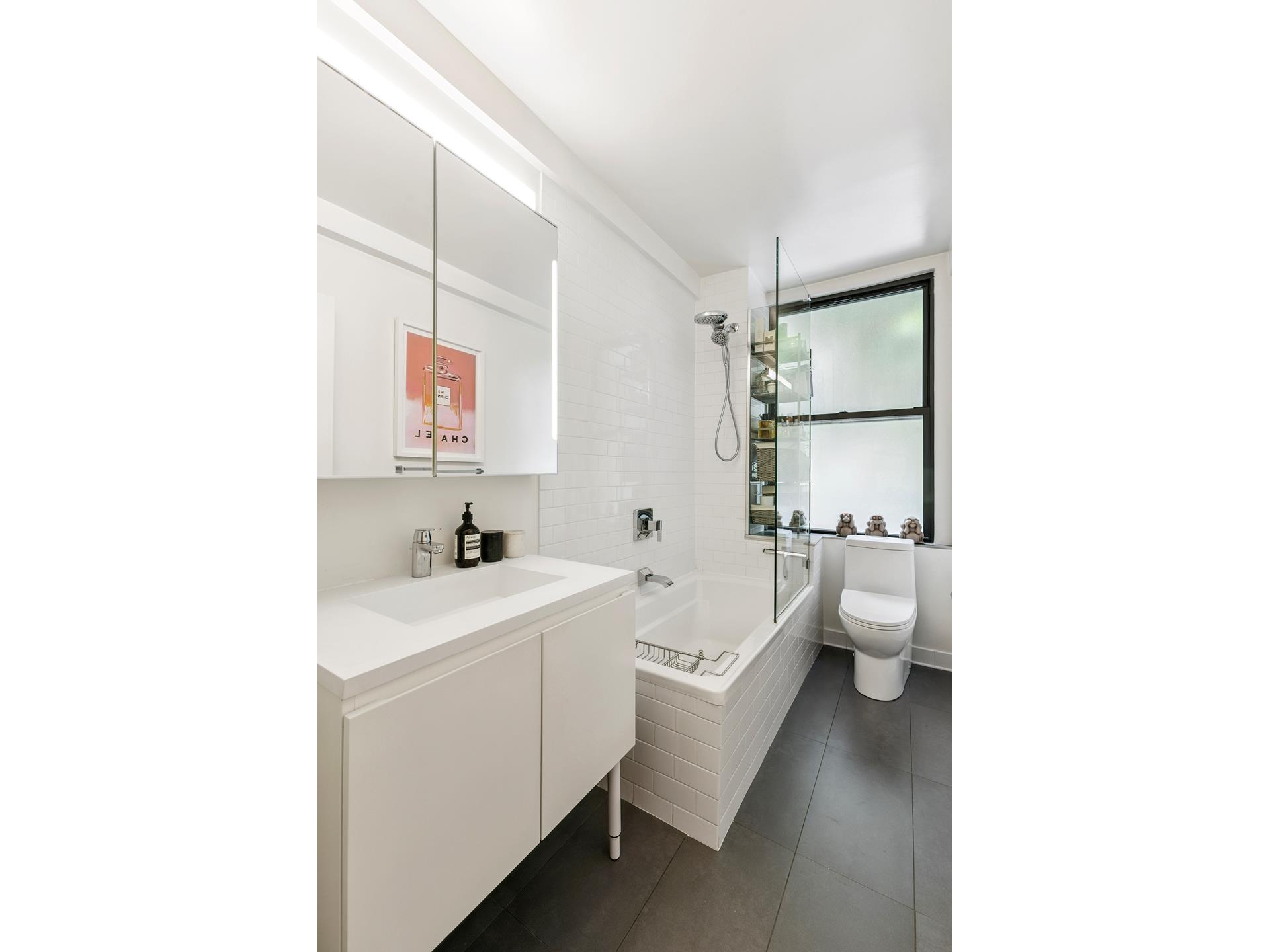 242 East 19th Street, Unit 2C Manhattan, NY 10003 - Photo 7 of 9 a bathroom with a sink a toilet and mirror