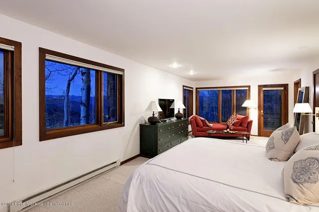 a bed room with two beds and a window