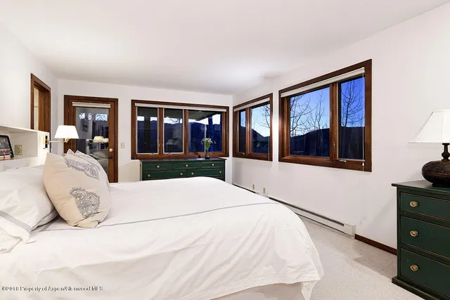 a large white bed in a white room