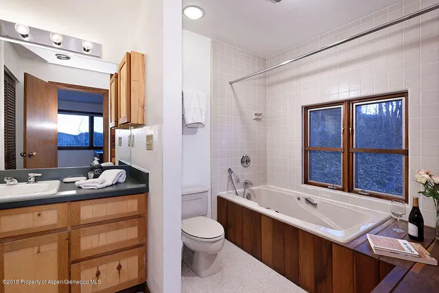 a bathroom with a sink double vanity and a toilet
