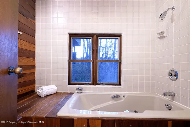 a bedroom with a bed and dresser