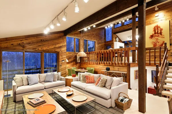 a living room with furniture a ceiling fan and a rug