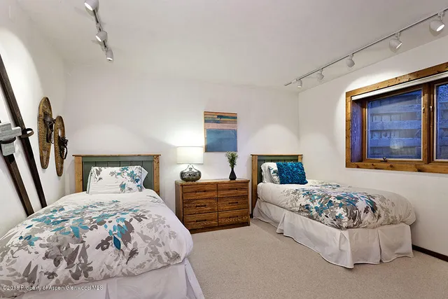 a bathroom with a granite countertop sink a mirror and shower