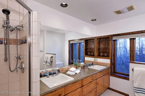 a bedroom with bed window and lamp