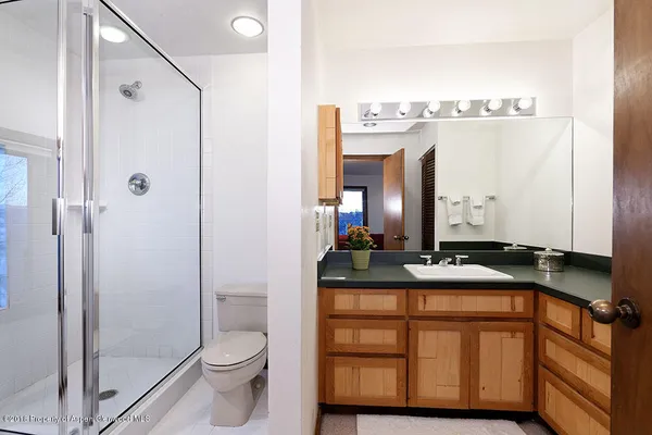 a bathroom with a sink a toilet and mirror