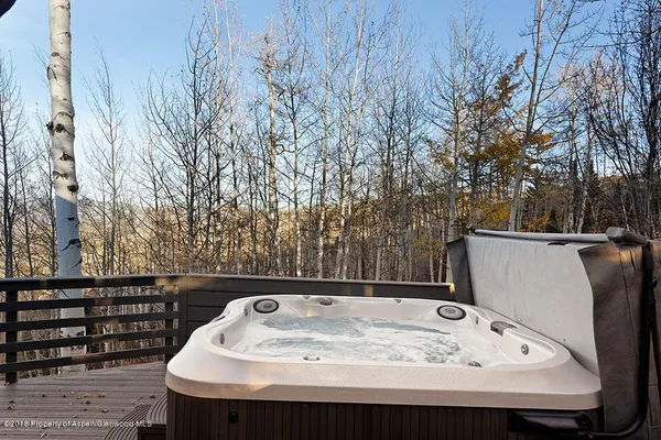 a living room with furniture kitchen view and a large window