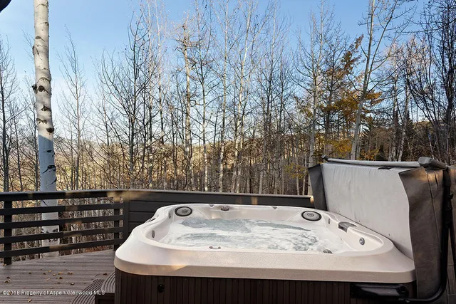a living room with furniture kitchen view and a large window